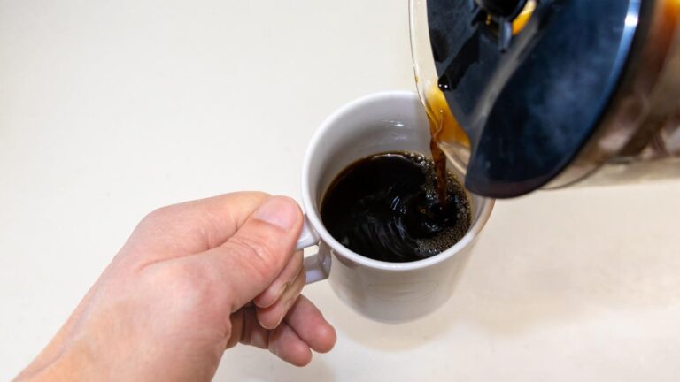 Want the Best Way to Brew Coffee? Use This Expert-Approved Method person pouring coffee into cup