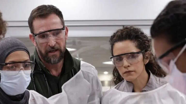 A group of attending doctors preside over a surgery