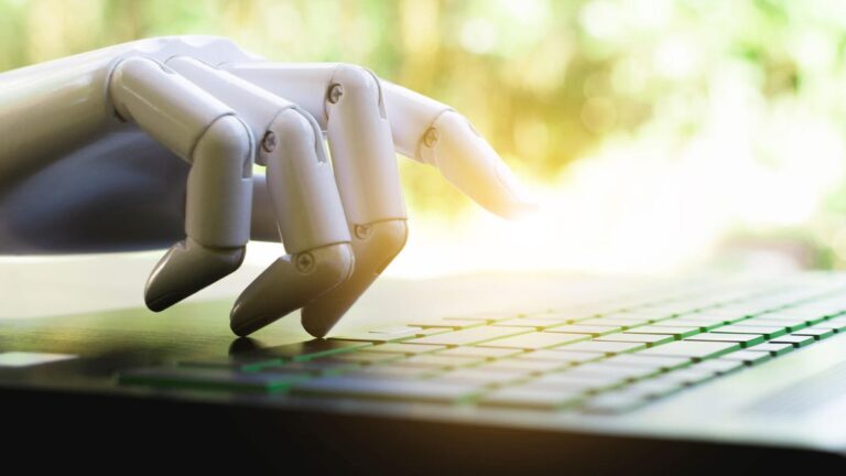 An image of a robot hand typing on a keyboard gettyimages-1065011316