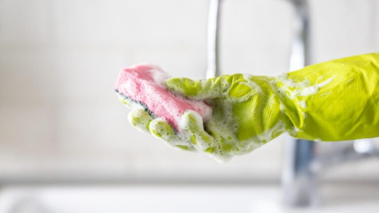 Black plastic kitchen tools on yellow background. Top view. Flat lay