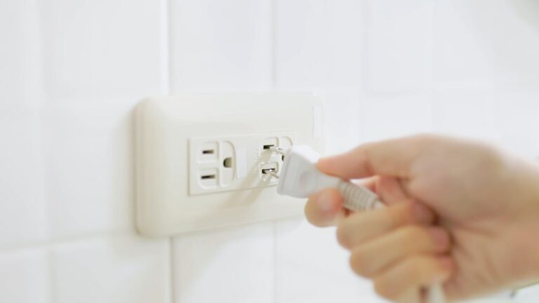 person unplugging cord